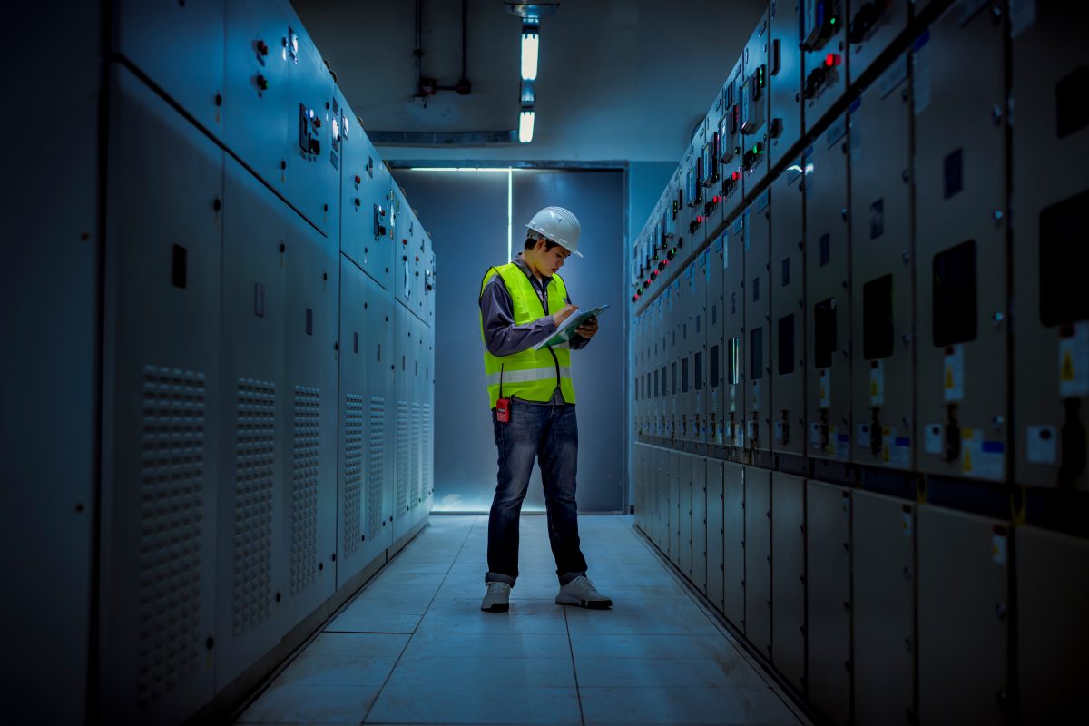 Manufacturing Engineer Checking Secure Server Room with CUI